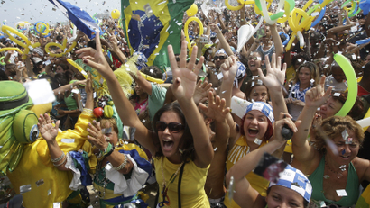 People celebrate after Rio de Janeiro won the nomination to host the 2016 Olympic Games at the Copacabana beach, in Rio de Janeiro
