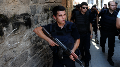 Turkish police officers conduct a security operation in Diyarbakir, southeastern Turkey, Saturday, Aug. 15, 2015.