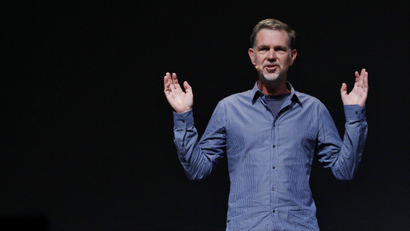 Reed Hastings of Netflix with his arms in the air