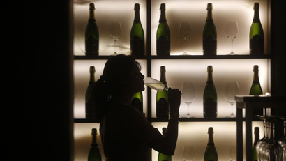 A woman poses with a glass of wine at a tapas bar in Mumbai March 9, 2013. Women who drink, long portrayed as less than respectable by Bollywood movies and still wary of entering most watering holes, are becoming big business in socially conservative India. Picture taken March 9, 2013.