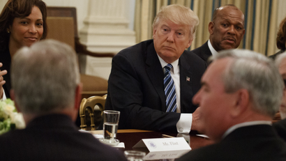 President Donald Trump listens during a meeting with airline executives in the State Dining Room of the White House in Washington, Thursday, Feb. 9, 2017. From left are, Deborah Ale Flint, executive director of Los Angeles World Airports; Trump; and UPS President of US operations Myron Gray.