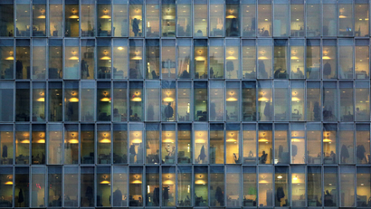 Lights are on as people work in their offices in a skyscraper in downtown Milan, February 17, 2015. REUTERS/Stefano Rellandini/File Photo GLOBAL BUSINESS WEEK AHEAD PACKAGE - SEARCH "BUSINESS WEEK AHEAD JULY 25" FOR ALL IMAGES - S1BETRNKOMAC