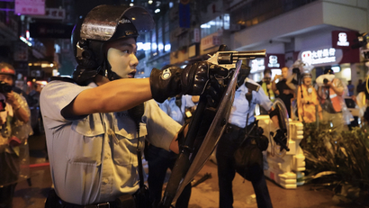Hong Kong police officer points gun at protesters