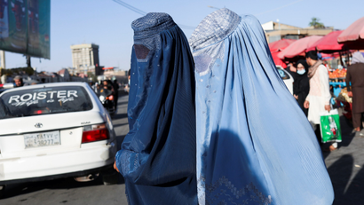 Afghan women walk down a street in Kabul