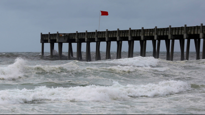 A red flag, warning of dangerous conditions, is seen on a pier in advance of Hurricane Michael in Pensacola, Florida, U.S. October 9, 2018. REUTERS/Jonathan Bachman - RC1CC6D88040