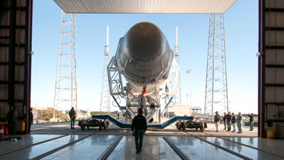 A Falcon 9 rocket leaves a hangar.