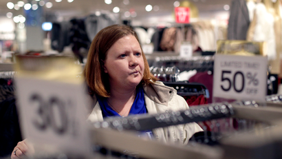 FILE - In this Saturday, Nov. 28, 2015, file photo, Janae Melvin shops for gifts at Forever 21 in Kansas City, Kan. Americans expressed a bit less optimism about the economy in January 2017 after their confidence soared to a 15-year high in December, according to information released Tuesday, Jan. 31, 2017, by the Conference Board.