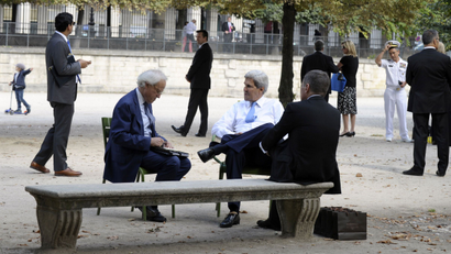 U.S. Secretary of State John Kerry (C) sits with U.S. Ambassador to France Charles Rivkin (R) and U.S. Special Envoy for Israeli-Palestinian negotiations Martin Indyk (L) at Les Tuilleries park in Paris September 8, 2013.