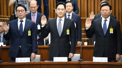 SK Group chairman Chey Tae-Won, Samsung Group's heir-apparent Lee Jae-yong and Lotte Group Chairman Shin Dong-Bin take an oath during a parliamentary probe into a scandal engulfing President Park Geun-Hye at the National Assembly in Seoul on December 6, 2016.