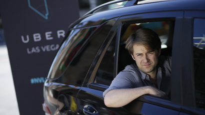 Uber West Coast Regional Manager William Barnes sits in the back of a car during a photo shoot Friday, Oct. 24, 2014, in Las Vegas. The ride sharing company has begun operations in Nevada. (AP Photo/John Locher)