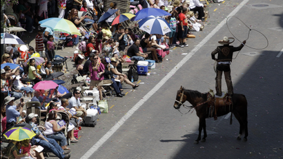 A charro performs rope tricks for parade goersin San Antonio, Texas.