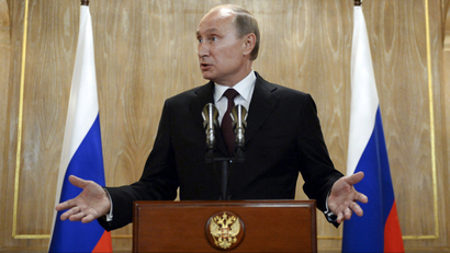 Russia's President Vladimir Putin gestures as he speaks during a news conference.