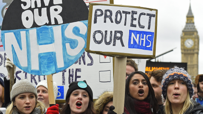 Junior doctors and NHS staff hold placards during a strike outside St Thomas' Hospital in London, Britain February 10, 2016. English doctors staged their second 24-hour strike on Wednesday over government plans to reform pay and conditions for working anti-social hours, in a move health chiefs have warned could put patients' lives at risk.