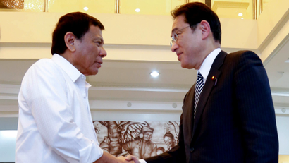 Philippine President Rodrigo Duterte, left, greets Japanese Foreign Minister Fumio Kishida