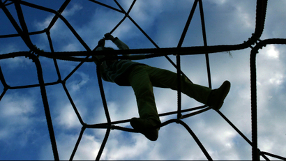 A child plays on a rope-climbing frame in northern Spain.