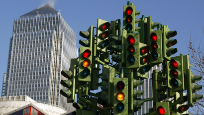 A sculpture with multiple traffic lights pointing in different directions