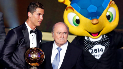 Portugal's Cristiano Ronaldo poses with FIFA President Sepp Blatter (C) and 2014 World Cup mascot Fuleco after being awarded the FIFA Ballon d'Or 2013 in Zurich January 13, 2014. Portugal and Real Madrid forward Cristiano Ronaldo was named the world's best footballer for the second time on Monday, preventing his great rival Lionel Messi from winning the award for a fifth year in a row.