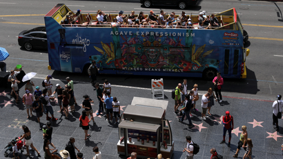 Tourists travel down Hollywood boulevard on a tour bus as they visit Hollywood, California, U.S.
