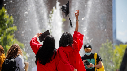 Graduates of The New School pose together in Washington Square Park in New York