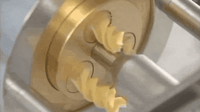 A gif of fusilli pasta being extruded from a bronze cutter. It is very satisfying.