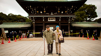 An elderly couple arrives at the Shinto Meiji Shrine to pray on the first day of the new year in Tokyo January 1, 2015.