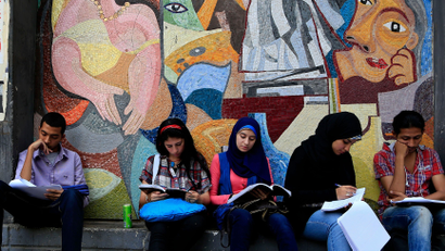 Art students from the University of Helwan study outside their university for their final year exams in the Zamalek neighborhood of Cairo, Egypt, Sunday, June 2, 2013.