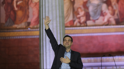 Alexis Tsipras, leader and head of radical leftist Syriza party, greets supporters after the initial election results for the Greece general elections in Athens, Greece, 25 January 2015.