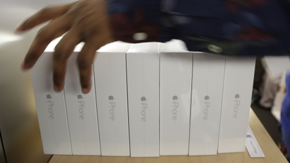 In this Sept. 19, 2014 file photo, an Apple store employee arranges a stack of pre-ordered iPhone 6 Plus models, in New York. Apple on Monday, Sept. 22, 2014 said it sold more than 10 million iPhone 6 and 6 Plus models, a record for a new model, in the three days after the phones went on sale. (AP Photo/Julie Jacobson, File)