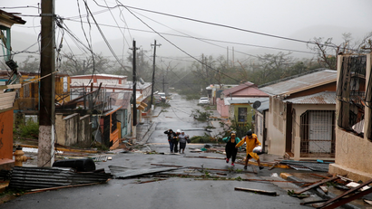 Rescue workers help people after the area was hit by Hurricane Maria in Guayama, Puerto Rico September 20, 2017. REUTERS/Carlos Garcia Rawlins