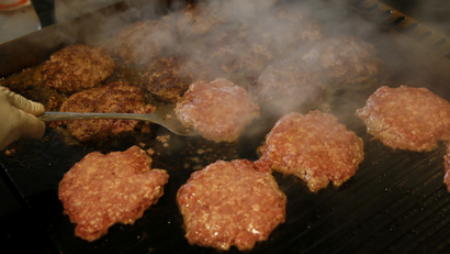 Burger patties on a hot stove cook