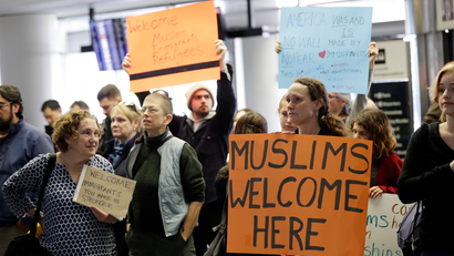 Protesters holds signs at San Francisco International Airport to denounce President Donald Trump's executive order that bars citizens of seven predominantly Muslim-majority countries from entering the U.S., Monday, Jan. 30, 2017, in San Francisco. (AP Photo/Marcio Jose Sanchez)