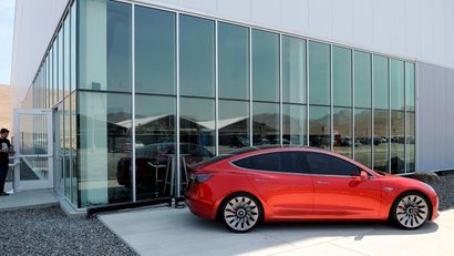 FILE PHOTO: A prototype of the Tesla Model 3 is on display in front of the factory during a media tour of the Tesla Gigafactory which will produce batteries for the electric carmaker in Sparks, Nevada, U.S. July 26, 2016. REUTERS/James Glover II/File Photo - RTS1459H