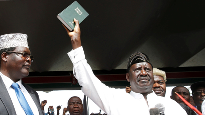 Miguna Miguna (left) was charged with treason for administering the oath to Kenyan opposition leader Raila Odinga.