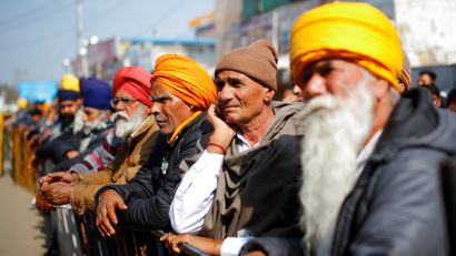 Farmers listen to a speaker during a protest against the farm laws at Singhu border near New Delhi, India, January 30, 2021.