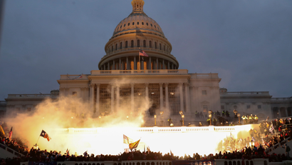 An explosion is seen in front of the US Capitol building.