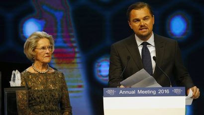 Actor Leonardo DiCaprio (R) delivers a speech after receiving a Crystal Award for his contribution to improve the state of the world from Hilde Schwab during the annual meeting of the World Economic Forum (WEF) in Davos, Switzerland January 19, 2016. REUTERS/Ruben Sprich