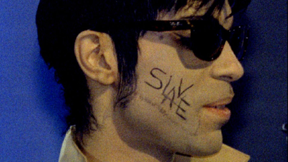 The man formerly known as Prince, with the word "Slave' written on his cheek, appears at the 1995 Brit Awards