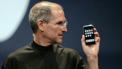 Apple Computer Inc. Chief Executive Officer Steve Jobs holds the new iPhone in San Francisco, California January 9, 2007. Apple unveiled an eagerly-anticipated iPod mobile phone with a touch-screen on Tuesday, priced at $599 for 8 gigabytes of memory, pushing the company's shares up as much as 8.5 percent. Jobs said the iPhone, which also will be available in a 4-gigabyte model for $499, will ship in June in the United States. The phones will be available in Europe in the fourth quarter and in Asia in 2008. REUTERS/Kimberly White