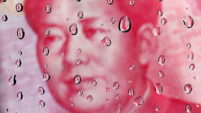 DATE IMPORTED:October 08, 2010A portrait of former Chinese leader Mao Zedong on a yuan banknote is reflected in water droplets in this picture illustration taken in Taipei October 8, 2010. REUTERS/Nicky Loh
