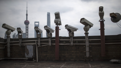 Security cameras are seen on a building at the Bund in front of the financial district of Pudong in Shanghai
