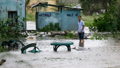 A resident wades along a flooded area as Typhoon Mangkhut barreled across Tuguegarao city in Cagayan province, northeastern Philippines on Saturday, Sept. 15, 2018. The typhoon slammed into the Philippines northeastern coast early Saturday, it's ferocious winds and blinding rain ripping off tin roof sheets and knocking out power, and plowed through the agricultural region at the start of the onslaught.