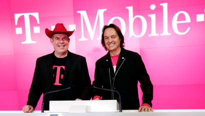 T-Mobile CFO Braxton Carter, left, and CEO John Legere pose together before ringing the opening bell at the NASDAQ Marketsite to celebrate T-Mobile's move to NASDAQ and the company's third quarter earnings report, Tuesday, Oct. 27, 2015 in New York.