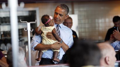Barack Obama holding a baby.