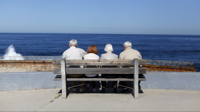 A pair of elderly couples view the ocean and waves