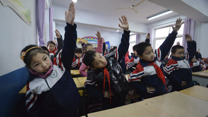 Primary school students practice morning exercises during class break in a classroom in Handan, Hebei province.