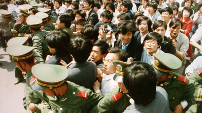 Crowds of jubilant students surge through a police cordon before pouring into Tiananmen Square on June 4, 1989 during a pro-democracy demonstration. This year marks the 10th anniversary of the bloody June 4 1989 army crackdown on the pro-democracy movement at Beijing's Tiananmen Square.
