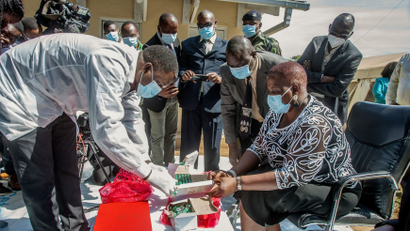 Malawi's health minister Khumbize Kandodo Chiponda examines vaccines before they are destroyed in Lilongwe on May 19. Malawi has destroyed nearly 17,000 doses of the AstraZeneca vaccine that had expired in mid-April, with the health minister blaming "propaganda" for many Malawians' reluctance to receive the jab.