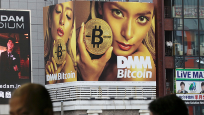 A huge advertisement of Bitcon is displayed near a train station in Tokyo Monday, Jan. 29, 2018. Blockchain is a decentralized technology that can make transactions safe and secure, but crypto-currency exchanges that trade bitcoins and other virtual currencies that are based on this technology have been hacked because they are not working on secure networks.