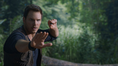 Chris Pratt holds up hand to stop dinosaur