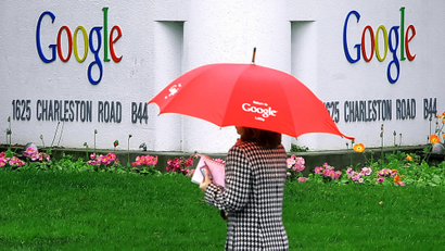 A woman walks past a street sign for Google in Mountain View, Calif., Monday, Jan. 30, 2006. Online search engine leader Google Inc. is expected to report more staggering financial growth after the stock market closes, but even a stellar fourth-quarter earnings report might not be enough to propel its high-flying stock. (AP Photo/Jeff Chiu)